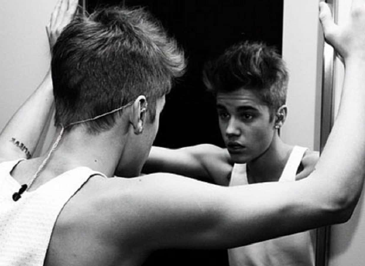 Grayscale Portrait Photo of Justin Bieber Looking into Mirror 