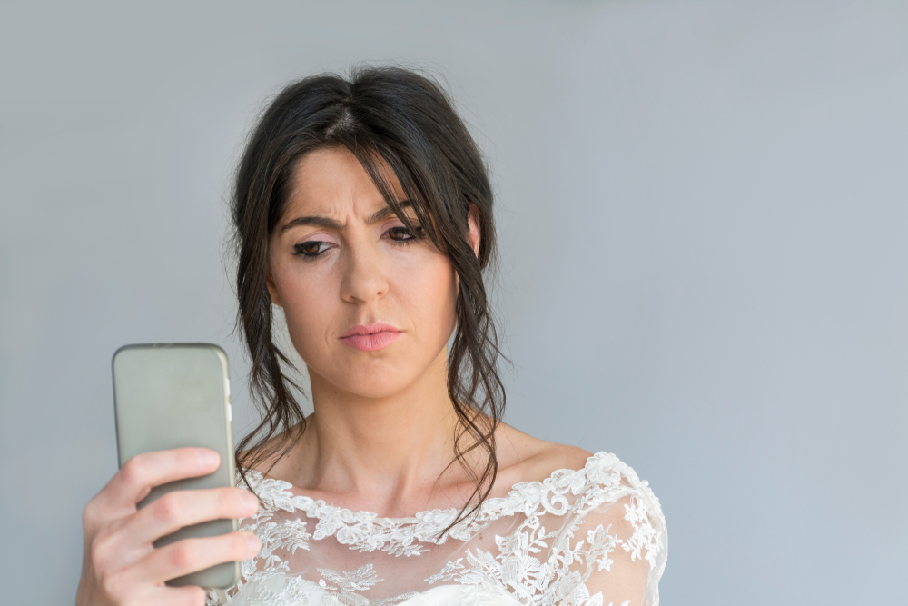Sad and Angry Bride  looking at a text on the phone