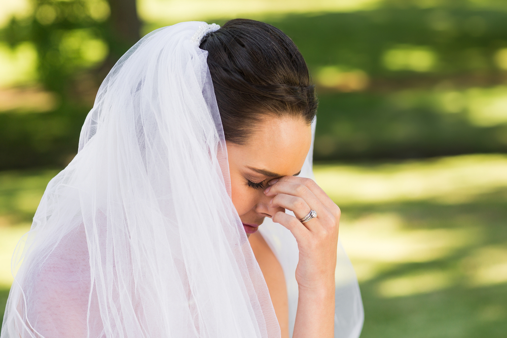sad and worried bride at the park