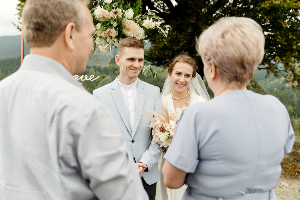 Elderly parents with a young wedding couple