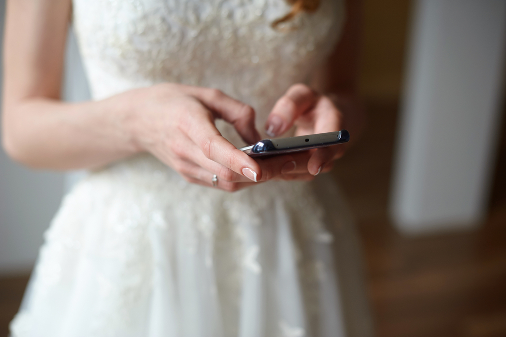 bride holding a  phone typing