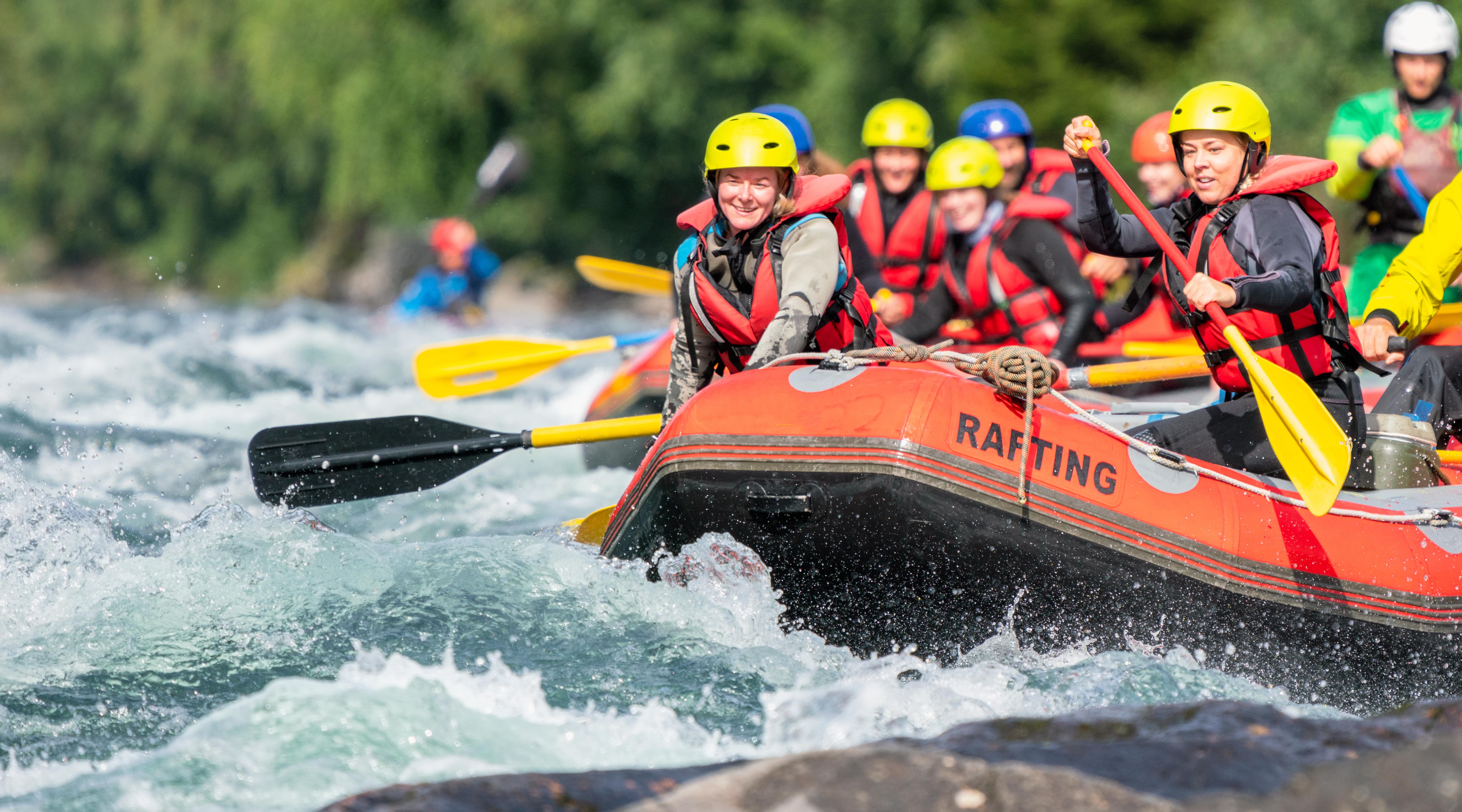 Group of people white water rafting