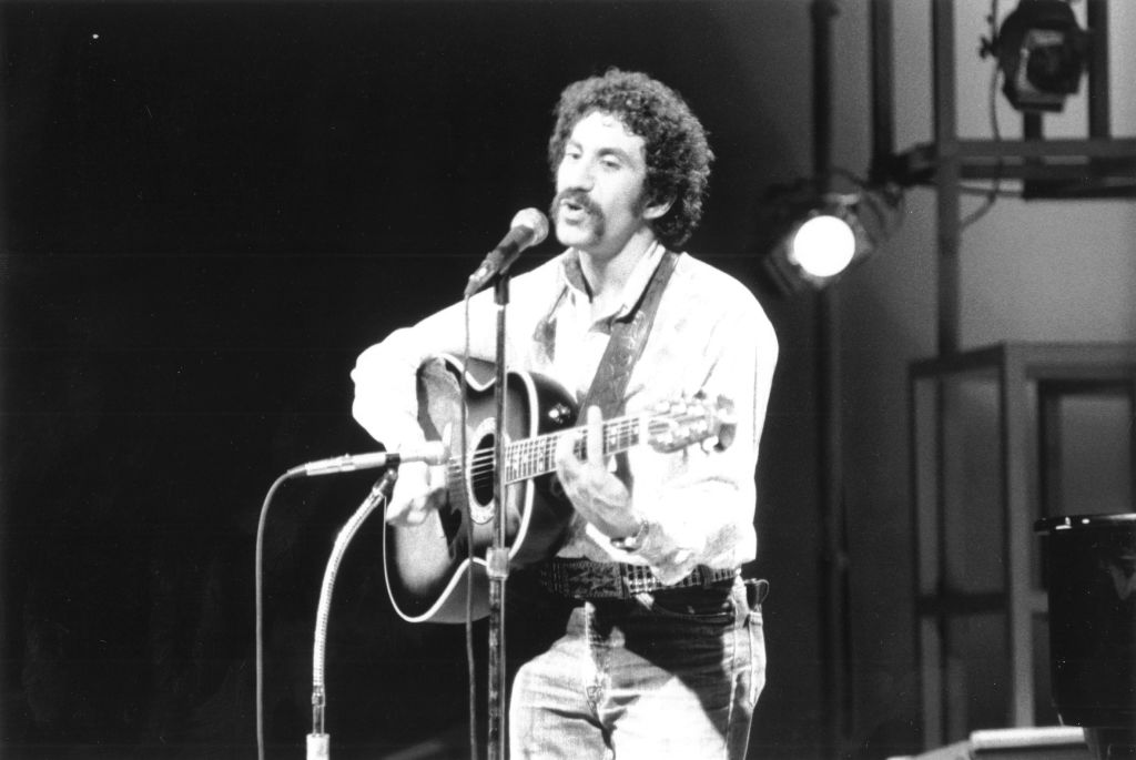 Jim Croce playing on his guitar