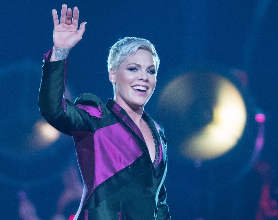 Pink wearing a black and purple outfit